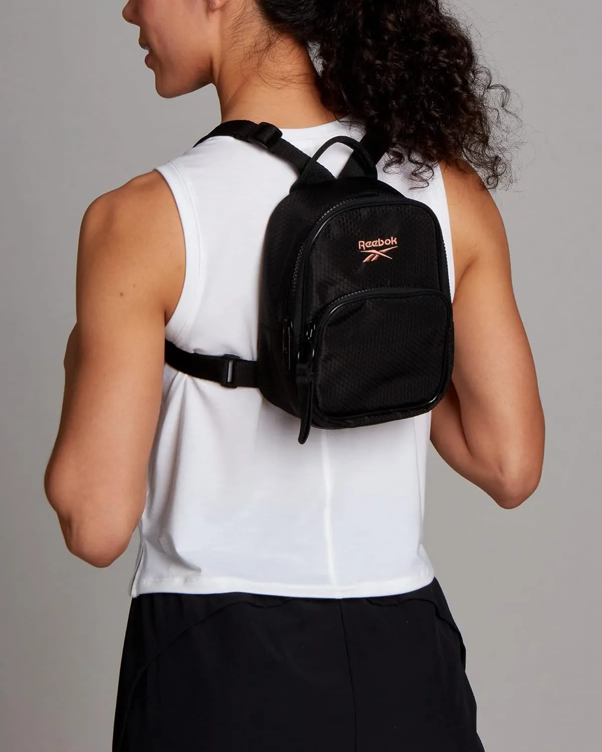 Reebok Women's Backpack - Lightweight Mini Essential Backpack - Small Casual Travel Bag, Black With Rose Gold Logo